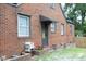 Brick exterior with a side entrance and a small awning, showcasing the home's practical design at 106 E Club Blvd, Durham, NC 27704