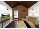 Cozy sunroom featuring brick accent wall, comfortable seating, and a modern television at 106 E Club Blvd, Durham, NC 27704