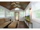Charming sunroom with wood ceiling, ample windows, and modern furnishings for relaxation at 106 E Club Blvd, Durham, NC 27704