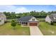 Aerial view of a well-kept house with a two car garage, landscaping and a spacious front yard at 106 Lockwood Dr, Cameron, NC 28326