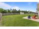 This backyard features a large green lawn, storage shed, and patio with chairs at 106 Lockwood Dr, Cameron, NC 28326