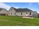 This backyard features a lovely green lawn and small concrete patio with lawn furniture at 106 Lockwood Dr, Cameron, NC 28326
