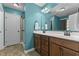 Bright bathroom features a double vanity with wood cabinets and modern fixtures, as well as tiled floors at 106 Lockwood Dr, Cameron, NC 28326