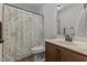 Cozy bathroom with patterned curtain, single vanity, and a toilet; compact yet functional at 106 Lockwood Dr, Cameron, NC 28326