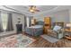 Spacious bedroom featuring hardwood floors, a ceiling fan, and large windows that flood the room with light at 106 Lockwood Dr, Cameron, NC 28326