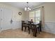 Dining room features natural light, a modern chandelier, and comfortable seating for six at 106 Lockwood Dr, Cameron, NC 28326