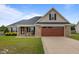 Charming brick home featuring a well-manicured lawn and an inviting two-car garage at 106 Lockwood Dr, Cameron, NC 28326