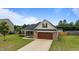 Charming home exterior with a well-manicured lawn, brick accents, and a welcoming front entrance at 106 Lockwood Dr, Cameron, NC 28326