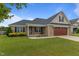 Beautiful brick home with well-maintained lawn and a two-car garage at 106 Lockwood Dr, Cameron, NC 28326