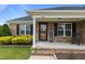 A welcoming front porch features decorative columns and a 'Welcome' sign at 106 Lockwood Dr, Cameron, NC 28326