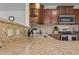 Kitchen featuring granite countertop, stainless steel appliances, and custom wood cabinets at 106 Lockwood Dr, Cameron, NC 28326