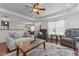 Open living room with hardwood floors, modern ceiling fan, and lots of natural light at 106 Lockwood Dr, Cameron, NC 28326