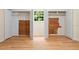 Unfinished basement with wood flooring, a window and closets with cedar paneling at 1085 Bynum Rd, Pittsboro, NC 27312