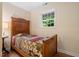 Cozy bedroom with wood floors and a window providing natural light at 1085 Bynum Rd, Pittsboro, NC 27312