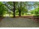 Long gravel driveway leading to a home surrounded by lush greenery at 1085 Bynum Rd, Pittsboro, NC 27312