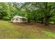 Charming single-story home surrounded by lush greenery and mature trees at 1085 Bynum Rd, Pittsboro, NC 27312