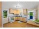Bright kitchen with light wood cabinets, white appliances, and natural light at 1085 Bynum Rd, Pittsboro, NC 27312