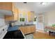 Bright kitchen with modern cabinets, blue counters, and a view of the backyard at 1085 Bynum Rd, Pittsboro, NC 27312
