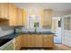 Kitchen with light wood cabinets, stainless sink, and a view to the exterior at 1085 Bynum Rd, Pittsboro, NC 27312