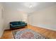 Open living room featuring a colorful rug and a comfy blue sofa at 1085 Bynum Rd, Pittsboro, NC 27312