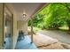 Covered porch with a view of a well-maintained gravel driveway and lush greenery at 1085 Bynum Rd, Pittsboro, NC 27312
