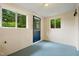 Utility room with blue painted floors and three windows letting in lots of light at 1085 Bynum Rd, Pittsboro, NC 27312