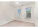 Cozy bedroom featuring carpeted floors, two windows, and neutral paint color scheme at 109 Ruby Walk Dr, Morrisville, NC 27560