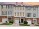 Charming townhouse exterior featuring a brick base, vinyl siding, and attached garages at 109 Ruby Walk Dr, Morrisville, NC 27560
