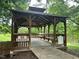 Enjoy peaceful moments in this shaded gazebo overlooking a serene pond, perfect for relaxation at 109 Ruby Walk Dr, Morrisville, NC 27560