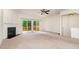Inviting living room featuring a fireplace, a ceiling fan, and access to a private deck at 109 Ruby Walk Dr, Morrisville, NC 27560