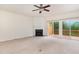 Bright living room featuring a fireplace, ceiling fan, and sliding doors to a deck at 109 Ruby Walk Dr, Morrisville, NC 27560