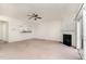 Cozy living room featuring a fireplace, ceiling fan, and sliding glass doors to the exterior at 109 Ruby Walk Dr, Morrisville, NC 27560