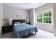 Bedroom with blue bedding, wood headboard, side tables, and window at 116 Hamilton Hedge Pl, Cary, NC 27519