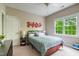 Cozy bedroom with carpet, large window and bed with a blue comforter at 116 Hamilton Hedge Pl, Cary, NC 27519
