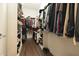 Walk-in closet with wood floors, hanging clothes, shelving and shoe racks at 116 Hamilton Hedge Pl, Cary, NC 27519