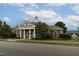 Welcoming community clubhouse with classic brick facade, columns, and manicured landscaping at 116 Hamilton Hedge Pl, Cary, NC 27519