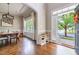 Bright dining room featuring hardwood floors, large windows, an elegant chandelier, and an open doorway at 116 Hamilton Hedge Pl, Cary, NC 27519