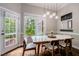 Inviting dining room with natural light, modern lighting, and a view of the backyard at 116 Hamilton Hedge Pl, Cary, NC 27519