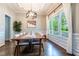 Bright dining room with hardwood floors, a modern light fixture and large windows with neighborhood views at 116 Hamilton Hedge Pl, Cary, NC 27519