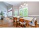 Elegant dining room with modern lighting, large windows, and hardwood floors at 116 Hamilton Hedge Pl, Cary, NC 27519
