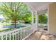 Inviting front porch with white railings, offering a serene view of the neighborhood and lush green trees at 116 Hamilton Hedge Pl, Cary, NC 27519