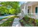 Charming front porch featuring white columns and railings, offering a glimpse of the peaceful neighborhood at 116 Hamilton Hedge Pl, Cary, NC 27519