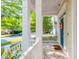 View of the front porch featuring white columns and railings, a blue front door, and neighborhood street views at 116 Hamilton Hedge Pl, Cary, NC 27519