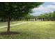 Expansive green space with mature trees, walking path, and charming gazebo for community enjoyment at 116 Hamilton Hedge Pl, Cary, NC 27519