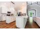 Bright, modern kitchen with white cabinets, dual islands, and hardwood flooring at 116 Hamilton Hedge Pl, Cary, NC 27519