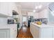 Bright kitchen featuring white cabinets, marble countertops, and hardwood floors at 116 Hamilton Hedge Pl, Cary, NC 27519