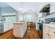 Stylish kitchen featuring white cabinets, a marble countertop, and stainless steel appliances at 116 Hamilton Hedge Pl, Cary, NC 27519