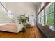 Bright living room featuring hardwood floors, large windows, and a staircase at 116 Hamilton Hedge Pl, Cary, NC 27519