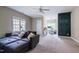 Spacious living area with a large couch, ceiling fan, and a built-in desk area at 116 Hamilton Hedge Pl, Cary, NC 27519