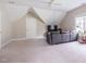 Comfortable living area featuring a plush gray sofa and ample natural light from a large window at 116 Hamilton Hedge Pl, Cary, NC 27519